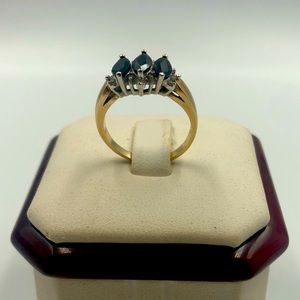 Dark sapphire with small diamonds on a 10K gold ring.